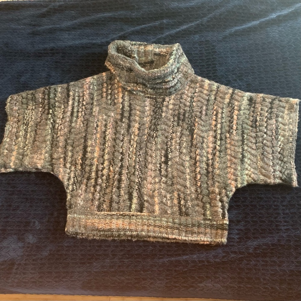 Multicolored bat wing sweater with cowl neck.